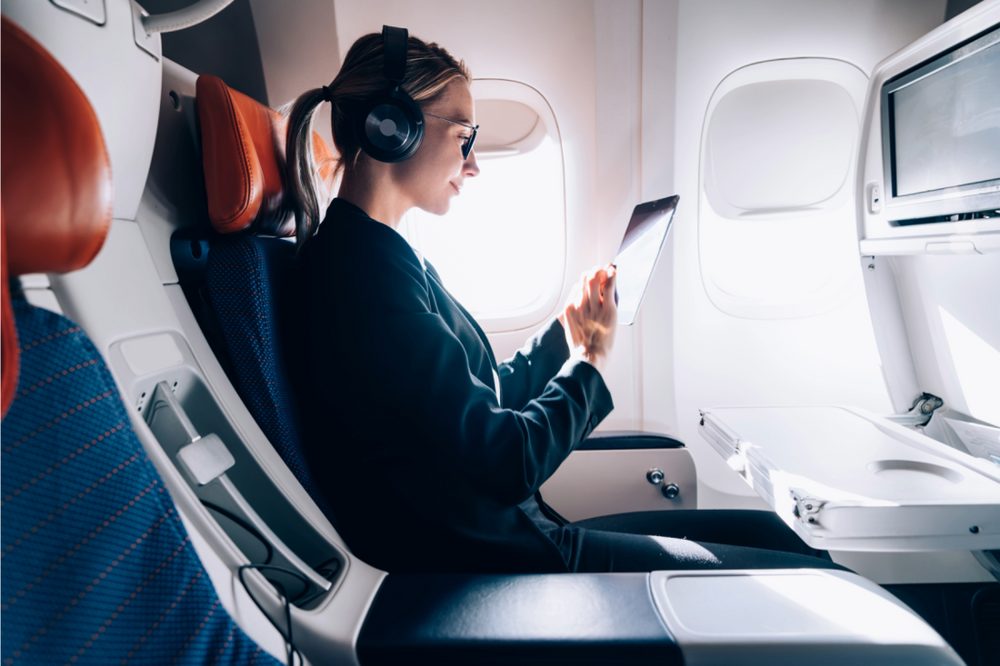 Travelling with dry eyes. A woman with glasses onboard a plane.