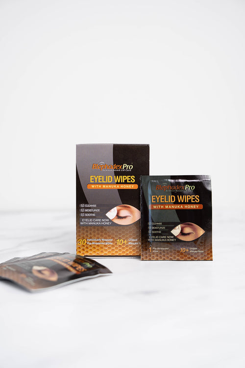 A 30-pack of Blephadex Pro Eyelid Wipes with Manuka Honey in a bathroom, for blepharitis and eyelid hygiene (view 1).