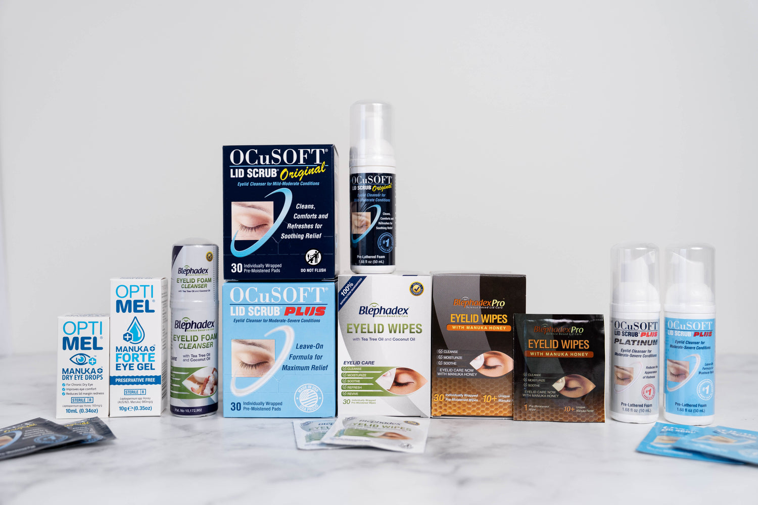 A photo showing various products at the One Stop Dry Eye Shop such as Optimel Eye Drops & Gel, Ocusoft Wipes & Foams, Blephadex Foam & Eyelid Wipes.