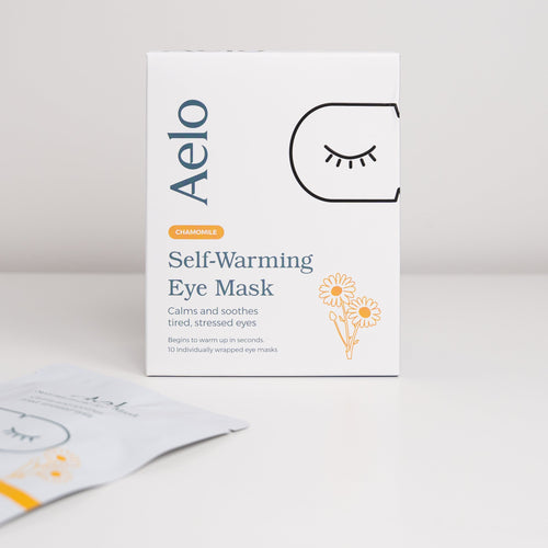A box of Aelo Self Warming Eye Mask with Chamomile on a light grey background.