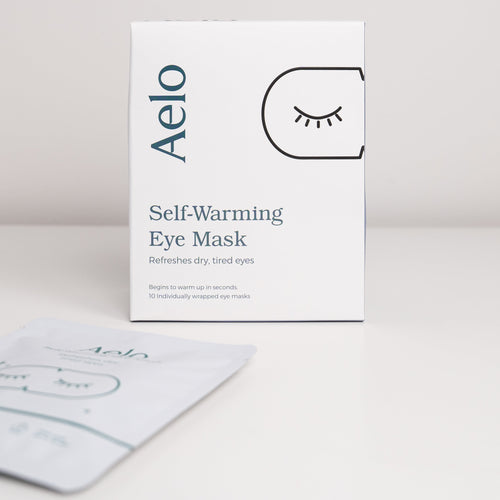 Aelo self-warming eye mask fragrance free packaging on a light gray background