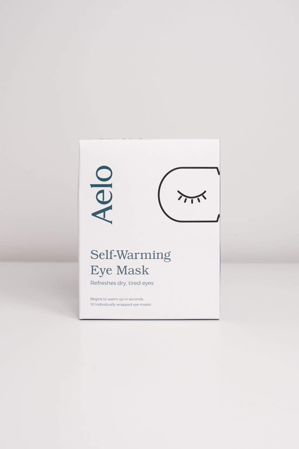 Aelo self-warming eye mask packaging on a light gray background