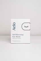 Aelo self-warming eye mask packaging on a light gray background