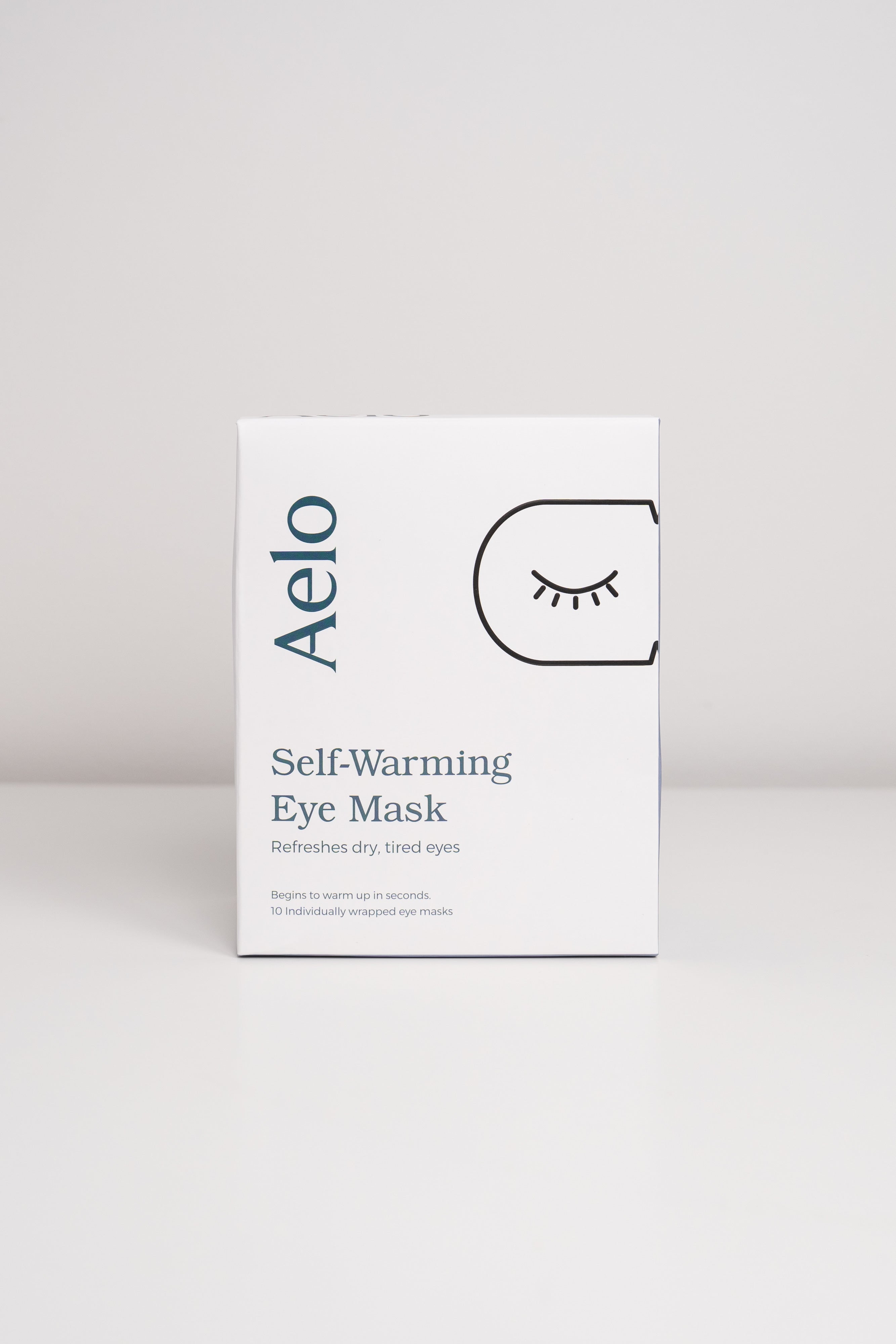 Aelo self-warming eye mask packaging on a light gray background
