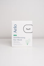 Aelo self-warming eye mask with Lutein packaging on a light gray background
