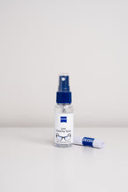 A bottle and cloth from the Zeiss lens cleaning kit, for cleaning eyeglasses and camera lenses.