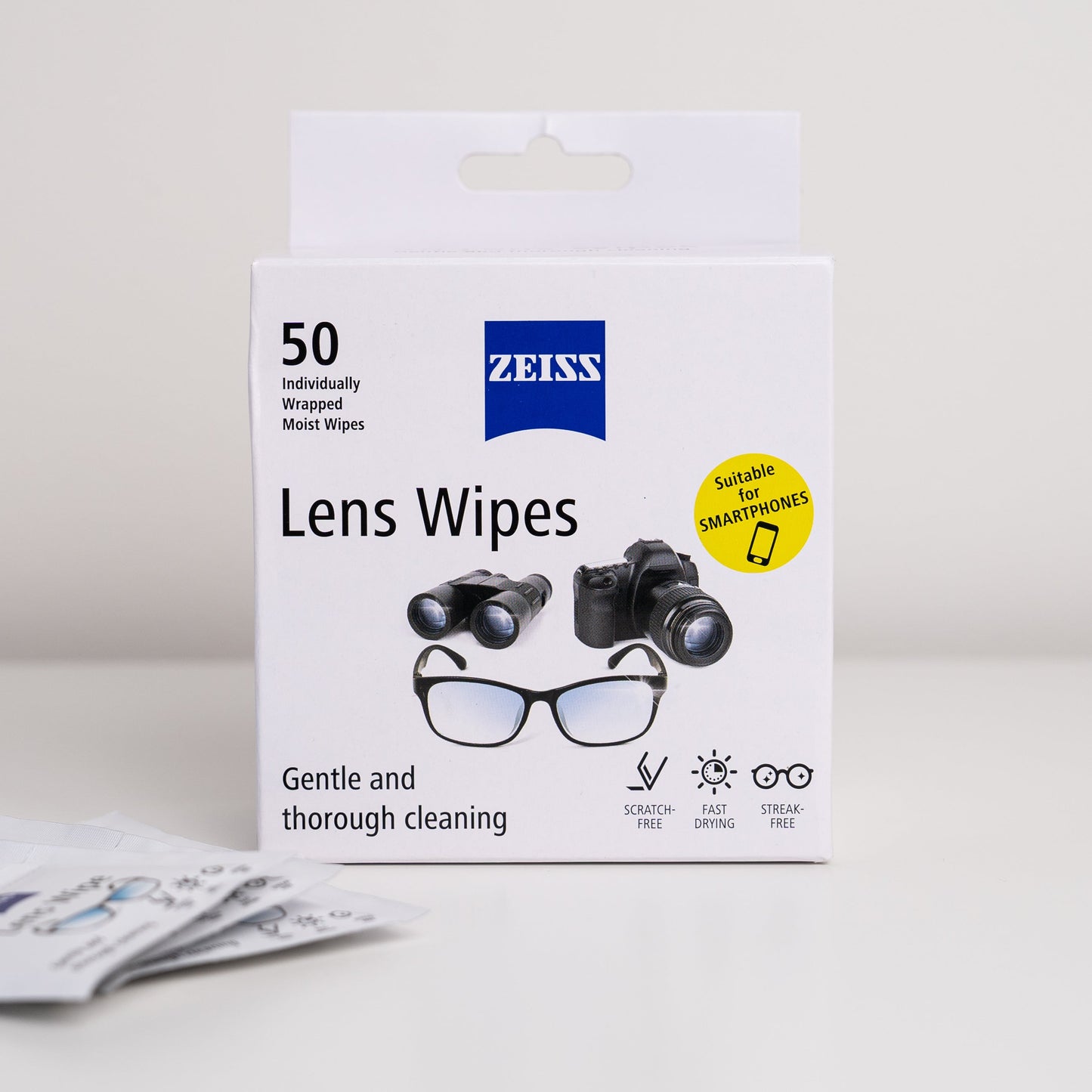 Box of Zeiss lens wipes with illustrations of glasses and camera on a light gray background