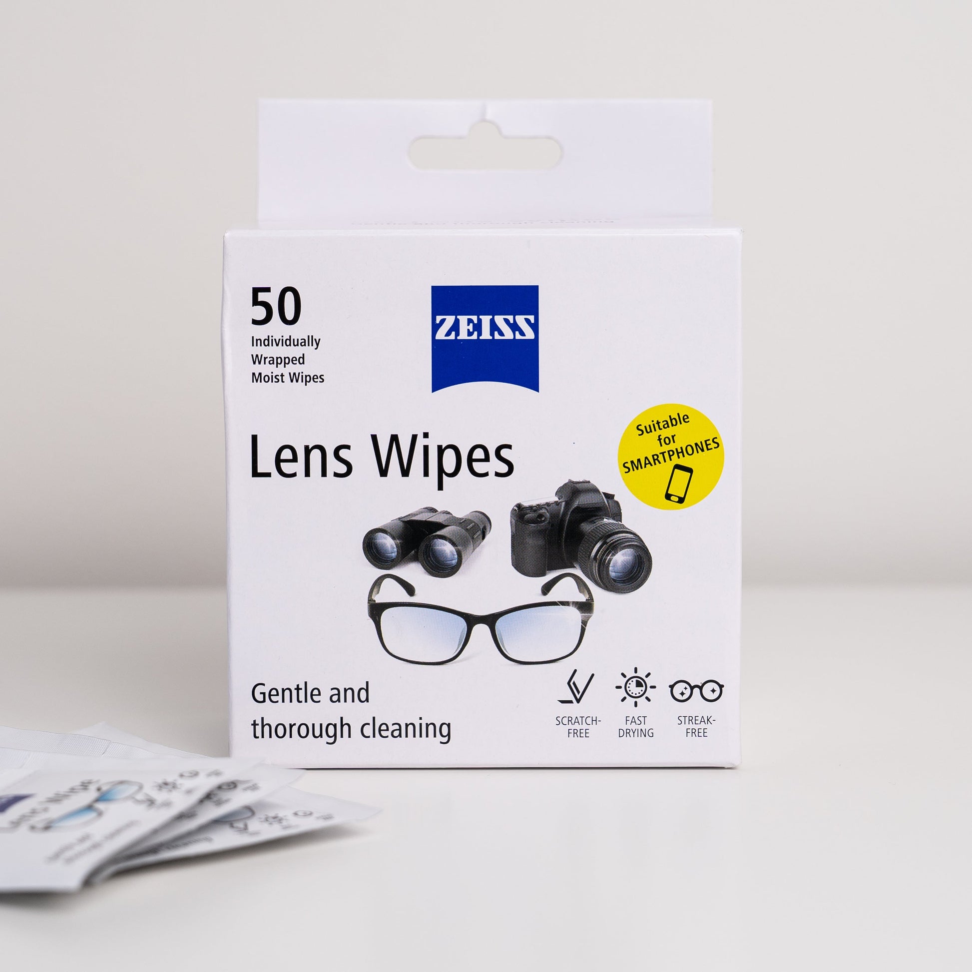 Box of Zeiss lens wipes with illustrations of glasses and camera on a light gray background